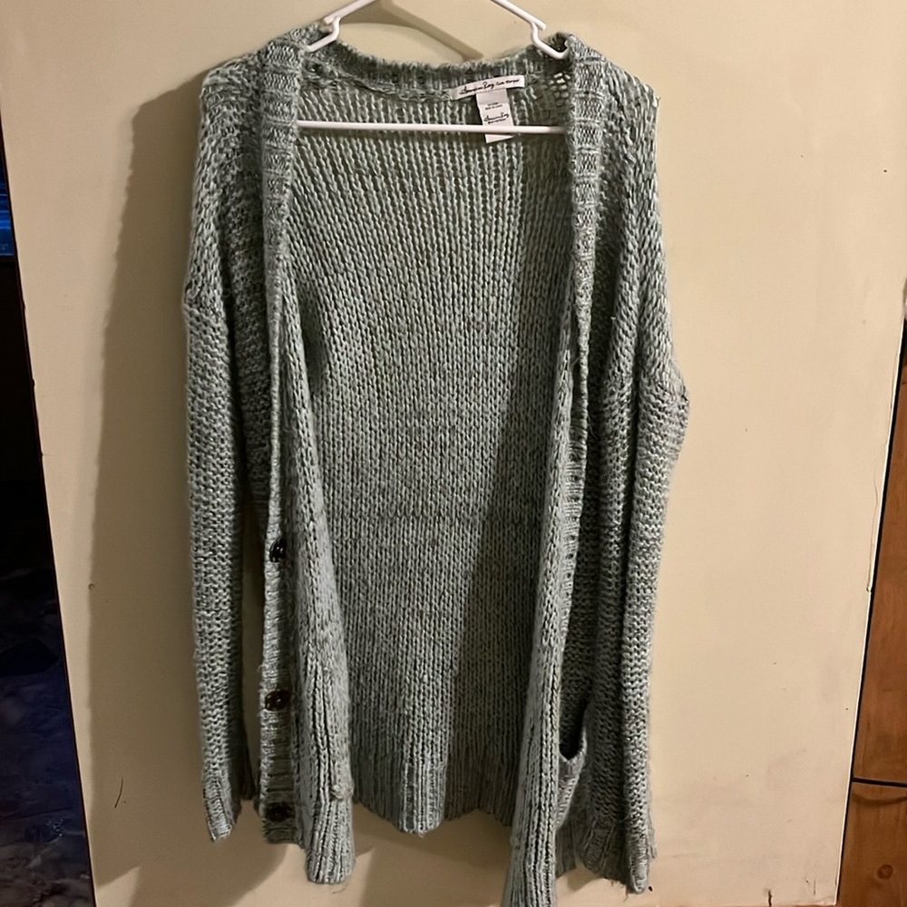 teal sweater with buttons and pockets